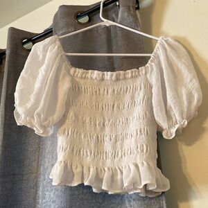 White Cropped top with half sleeves.
